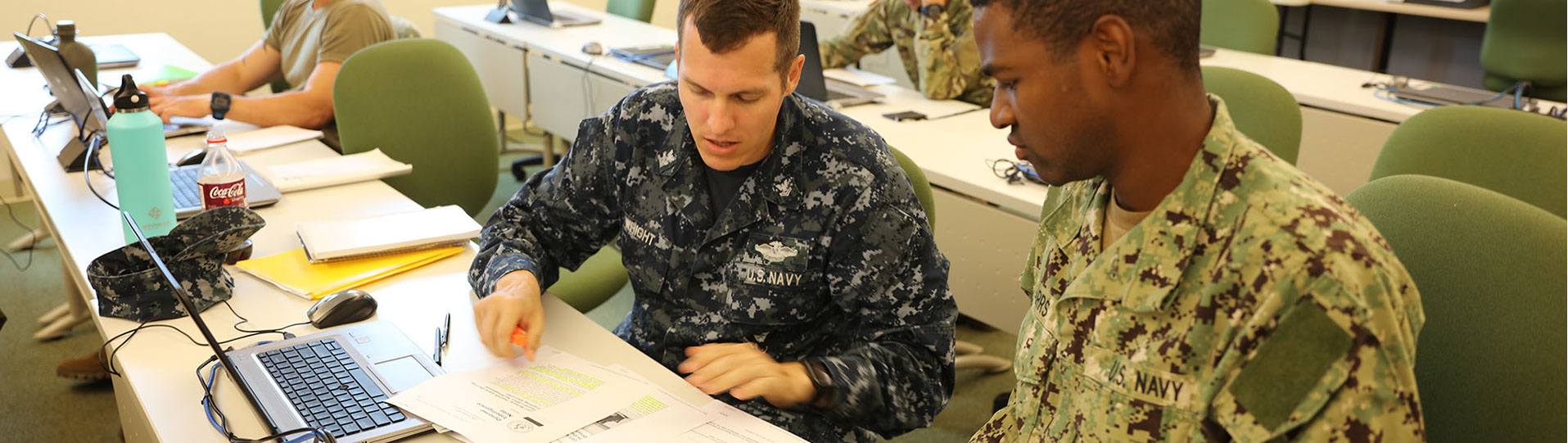 Professor training student in military uniforms