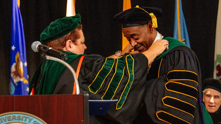 Dr. Nancy Dickey bestowing presidential medallion upon Dr. Jonathan Woods